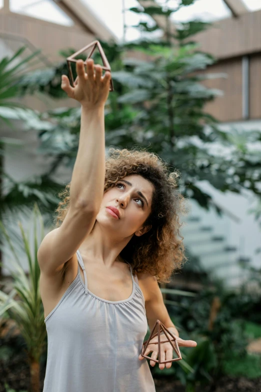 a woman holds up a cellphone with one hand