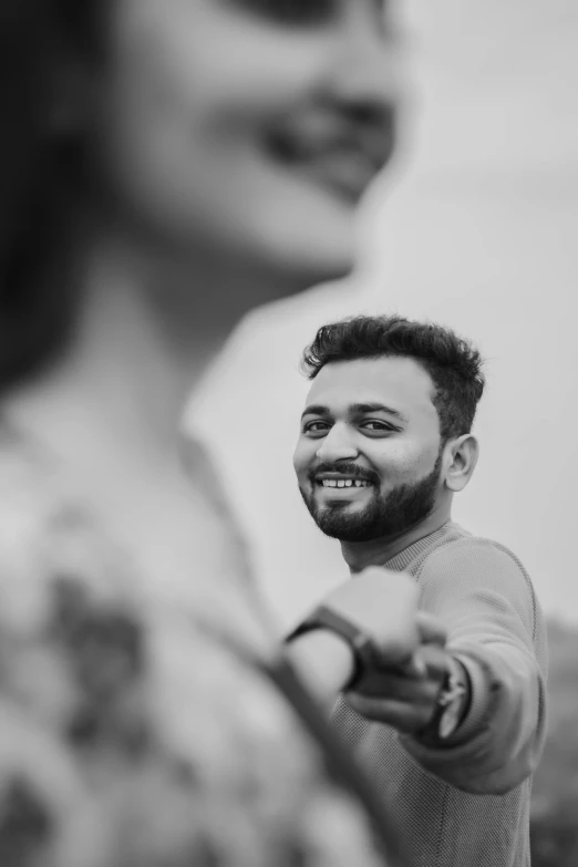 a black and white po of a man smiling