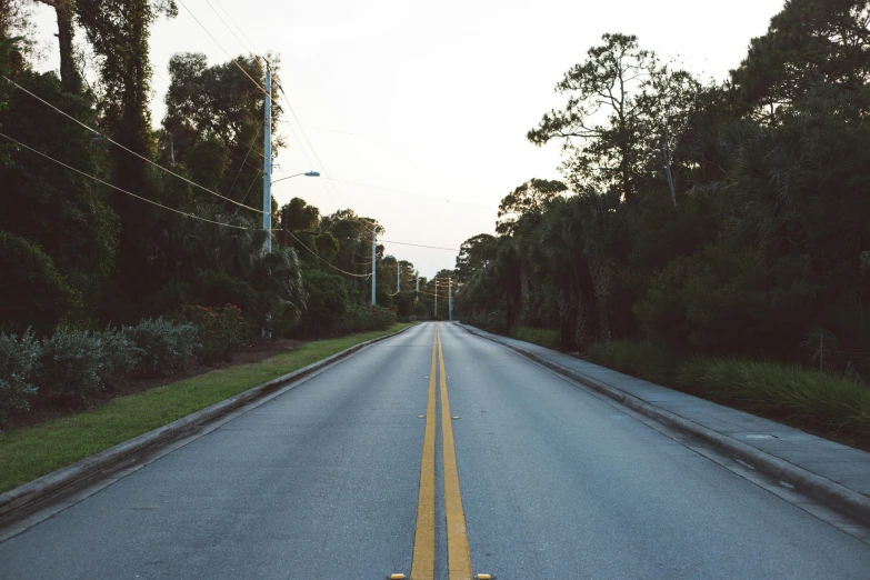 the road with no traffic has a yellow line