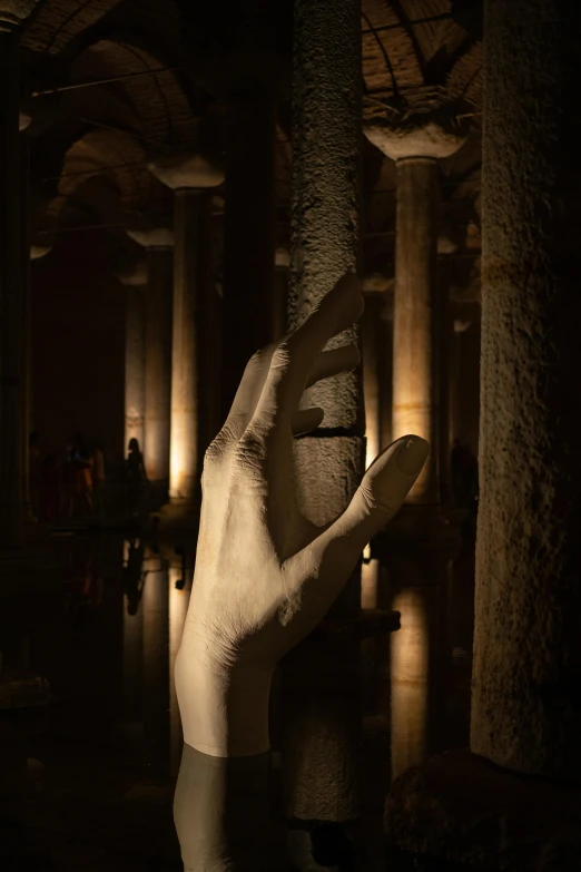 the hand that is holding soing up is shown in front of pillars