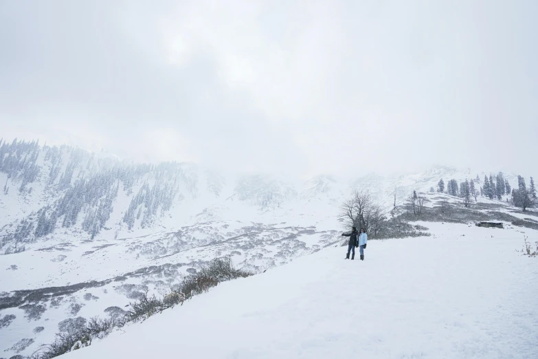 the person is standing on a ski hill