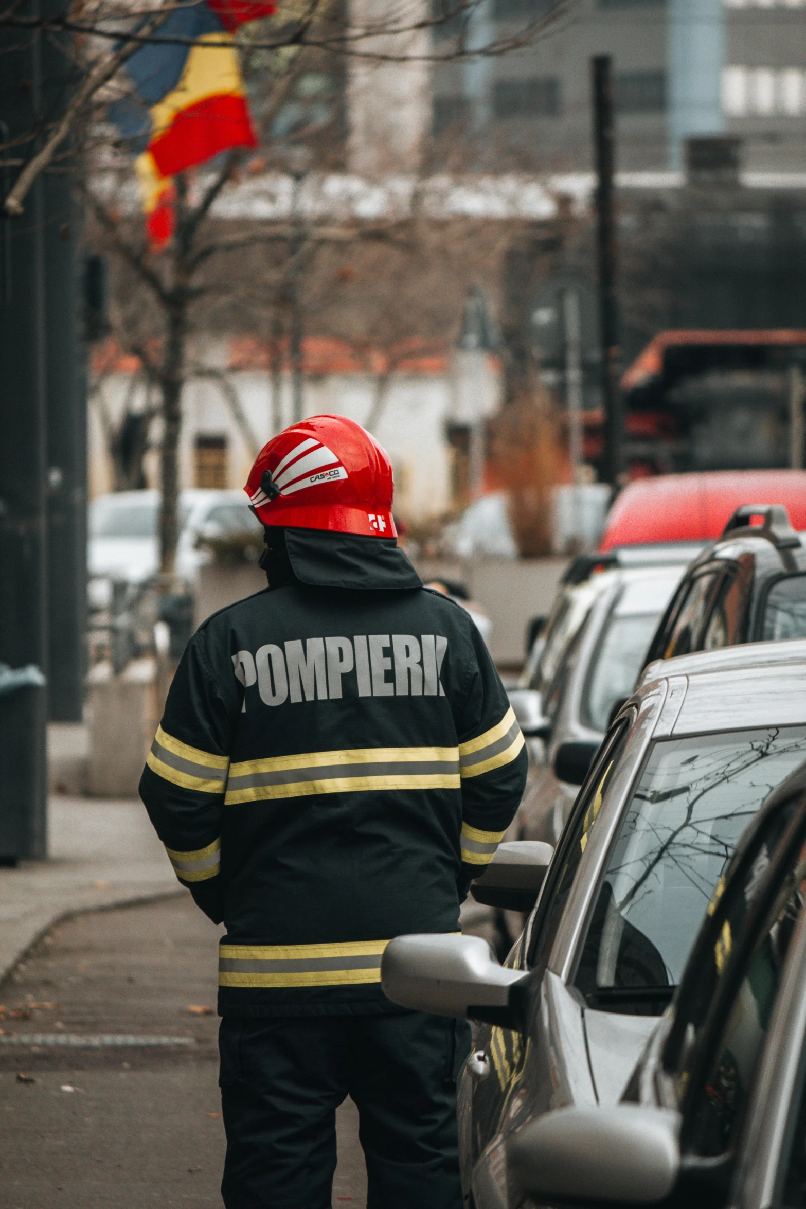 a fireman is standing in front of a line of cars