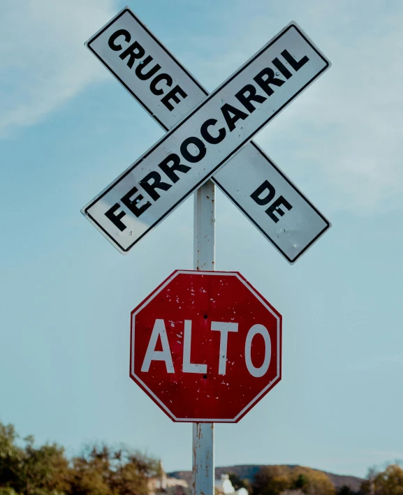 a stop sign has the words'prono, erroocari, and'alto written on it