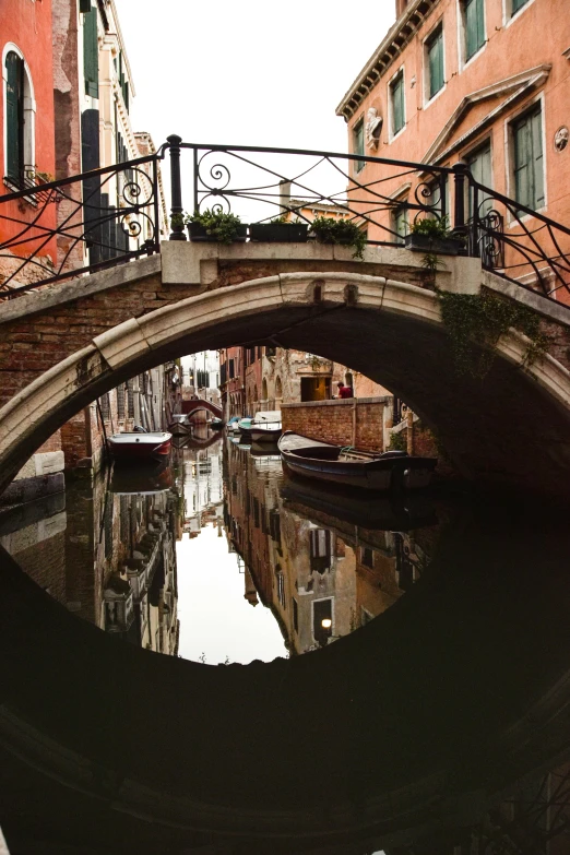 the canal is running between two buildings with boats on them