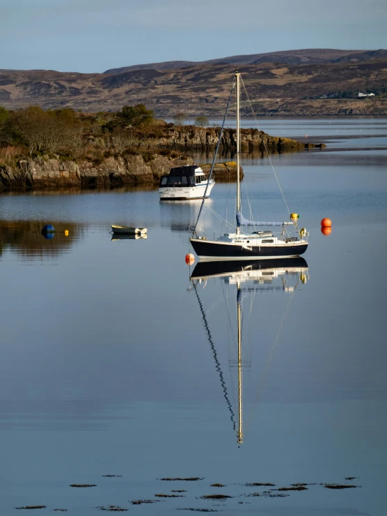 several small boats float on the clear water