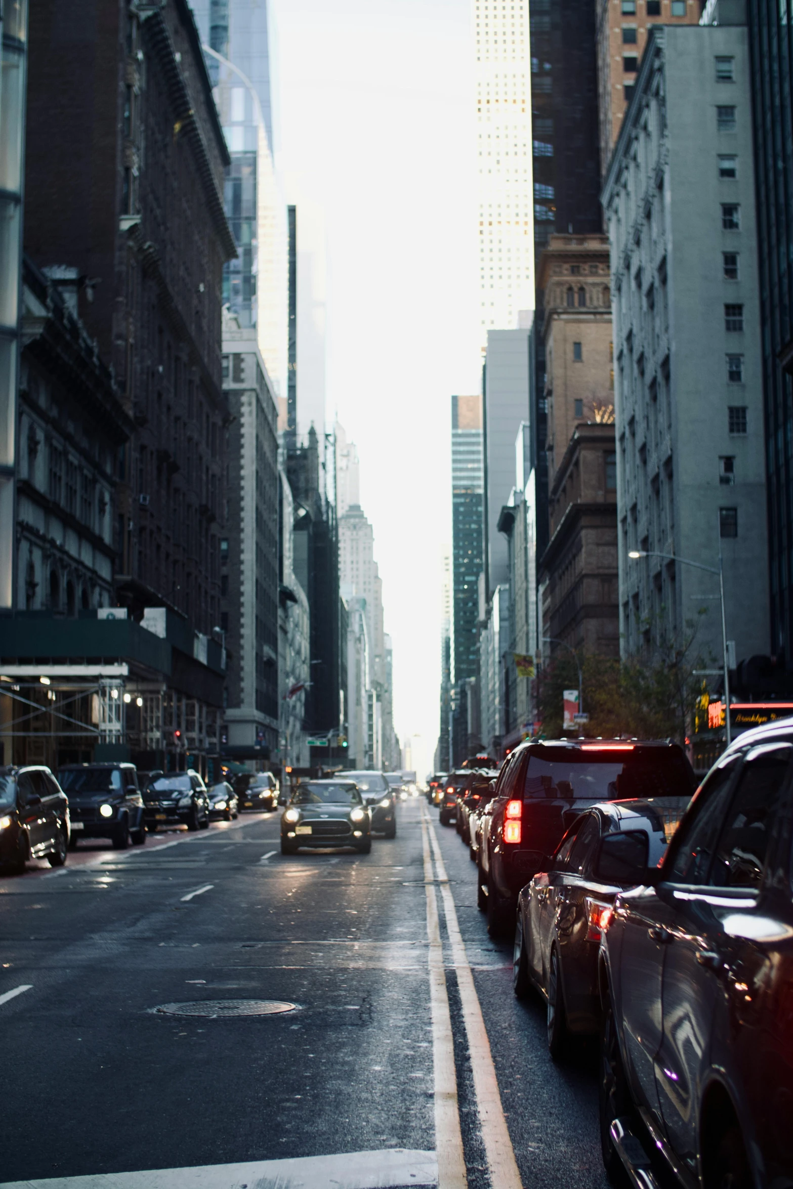 a street with tall buildings, cars, and skyscrs