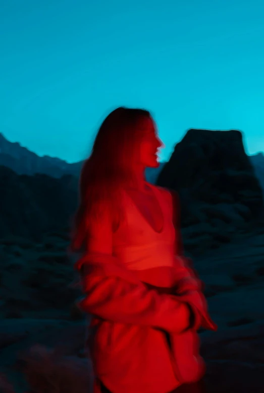 a woman standing in the desert at night