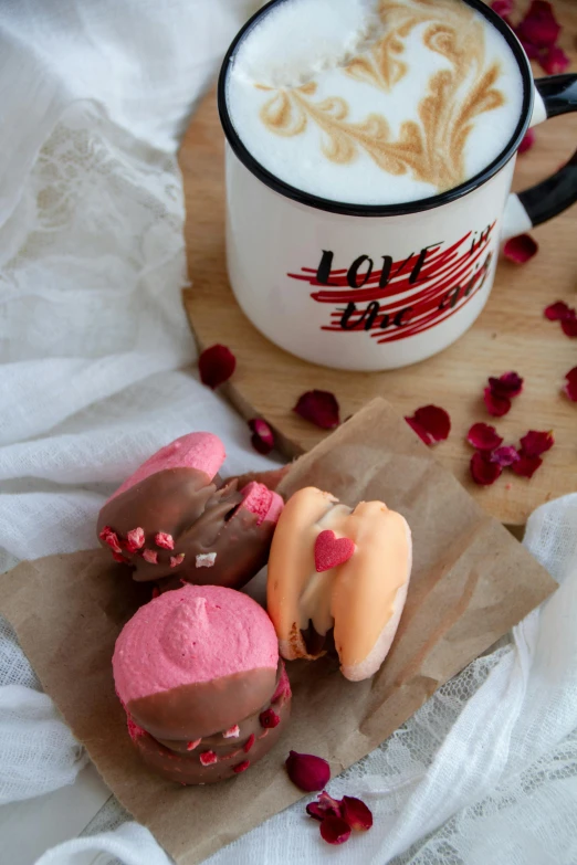 assorted pastries in paper on parchment paper beside coffee