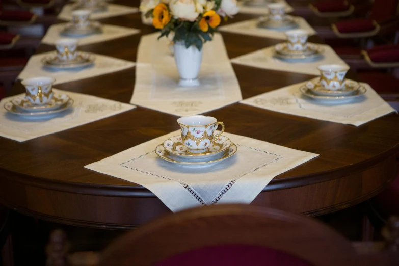 there is a table set with a fancy vase