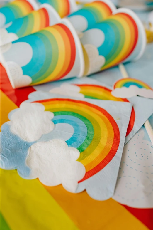 several rainbow shaped paper napkins sitting on top of a table