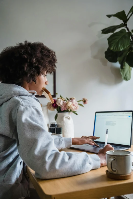 a person is using a laptop computer while sitting at the table