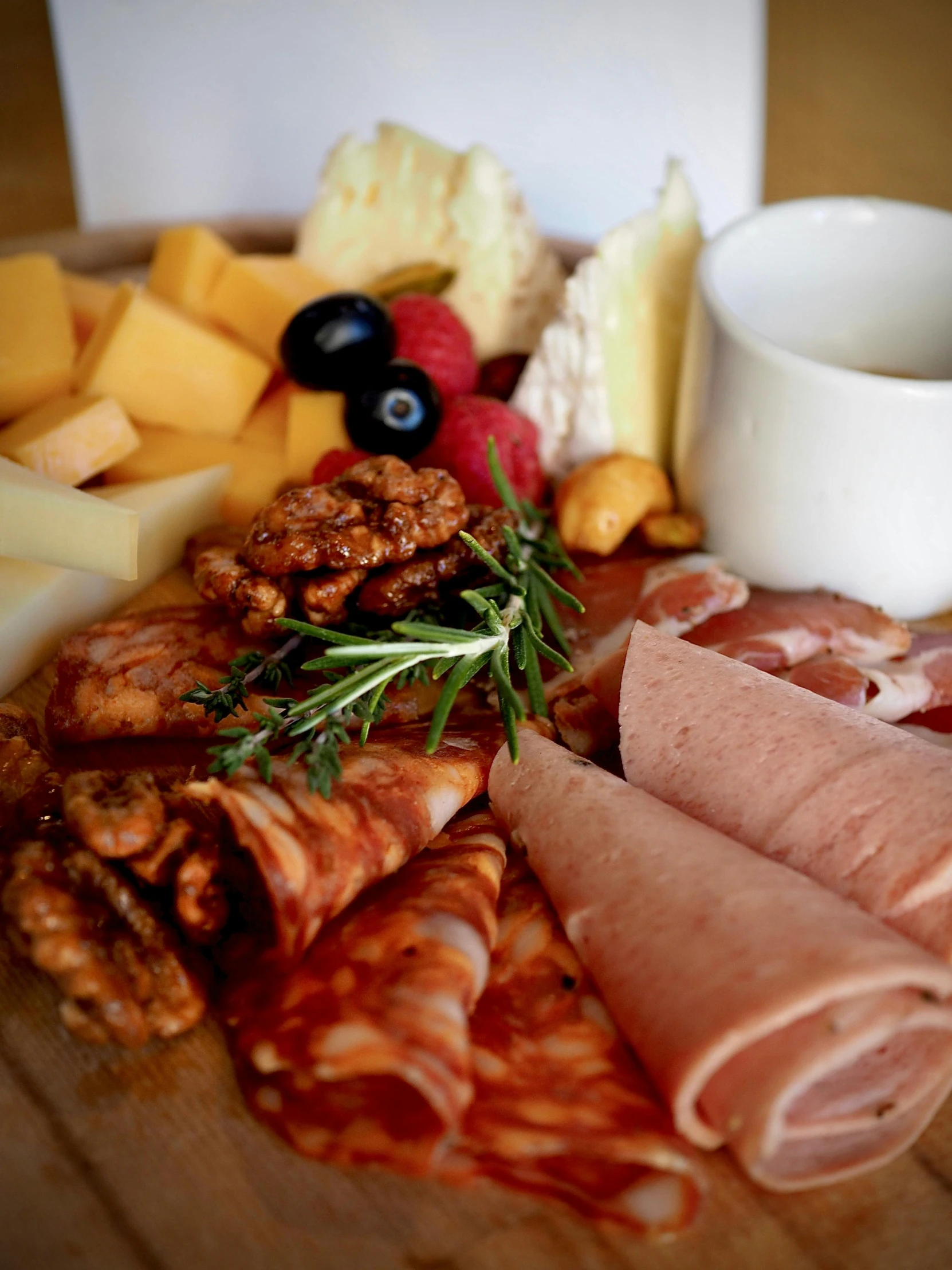 the meat platter includes different types of meats, cheeses and other snacks