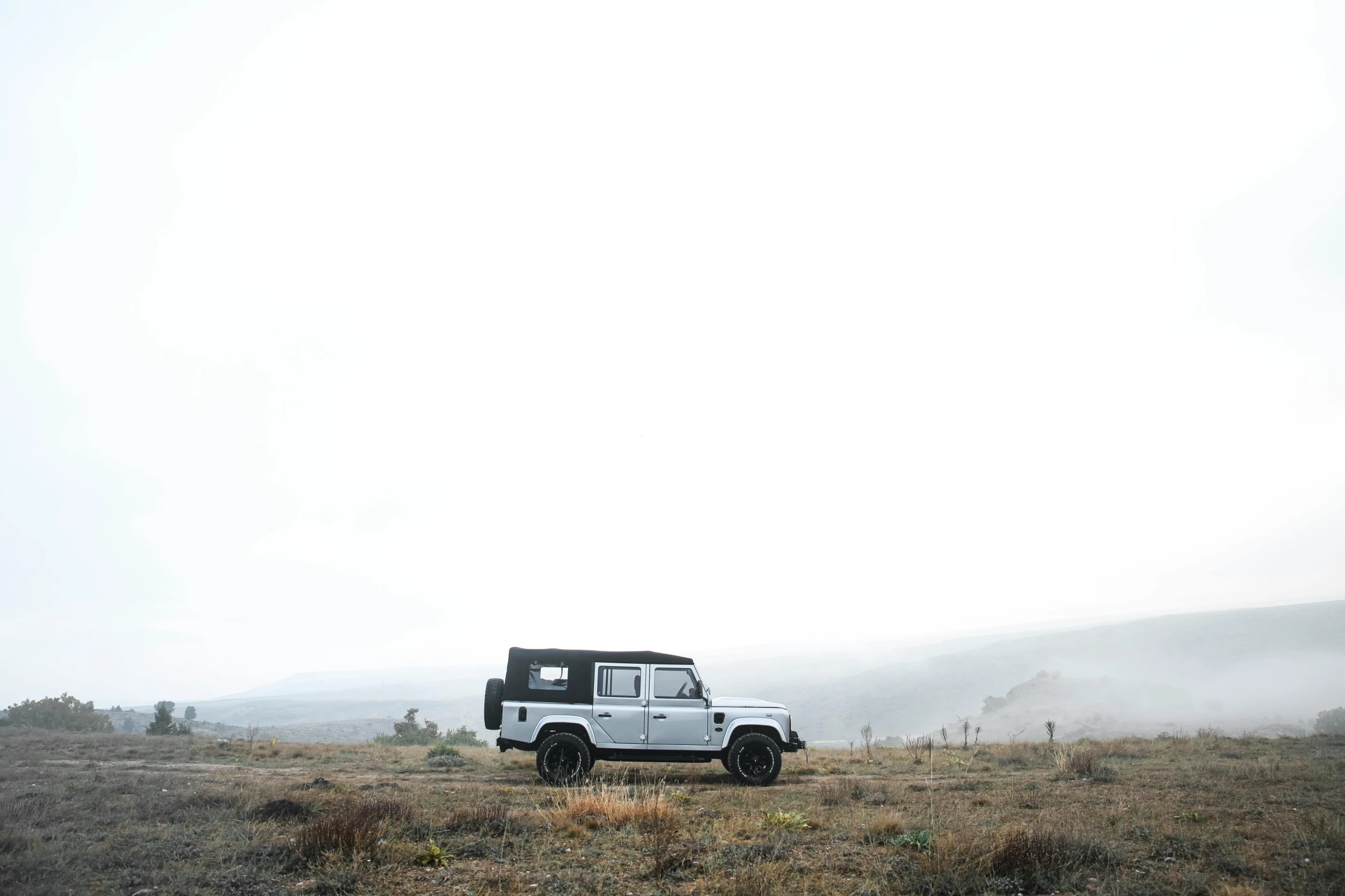 a jeep parked out in the open field