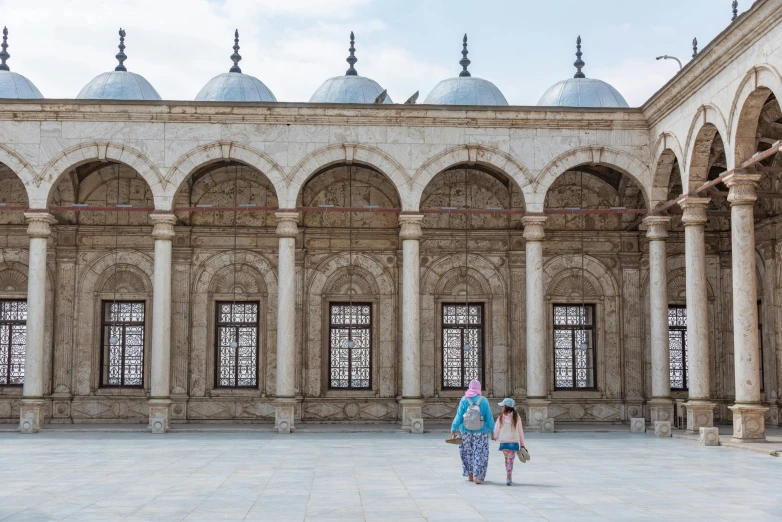 a woman and child walking into a building