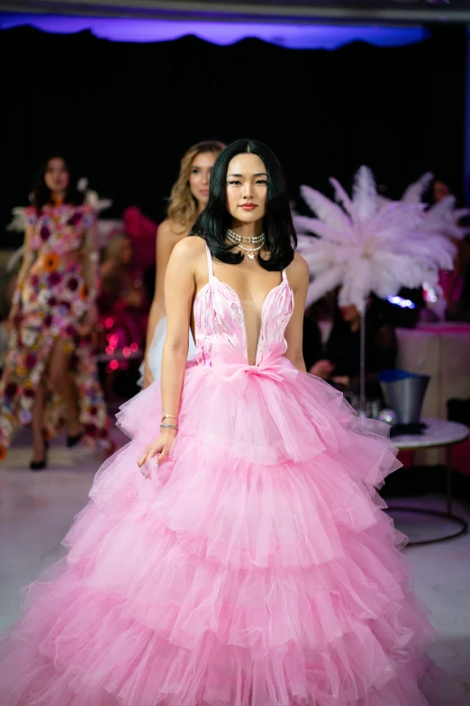 woman with large  and long dress on runway