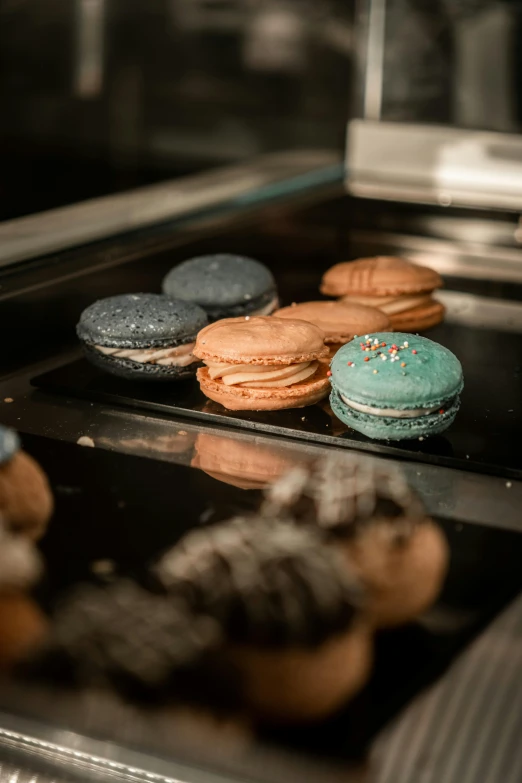 there are many colorful, round pastries on a tray