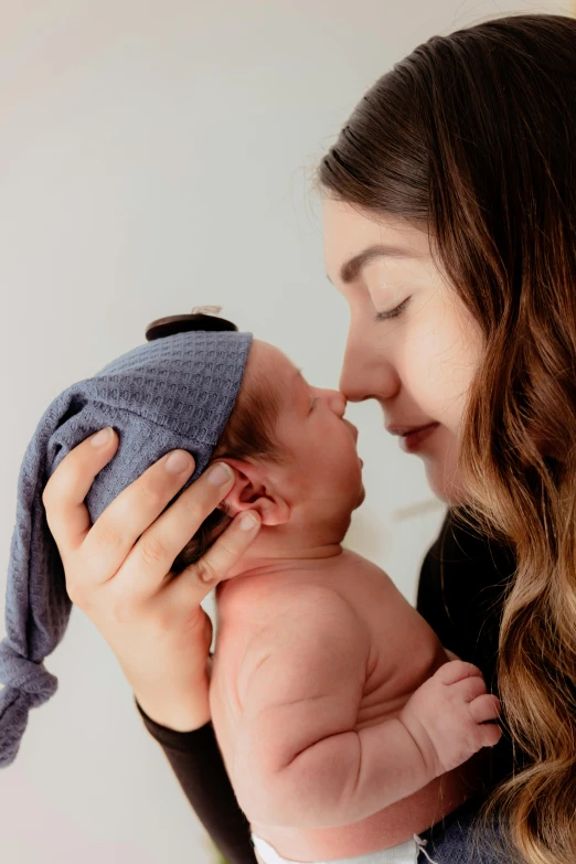 the baby is being cradled up close by his mom