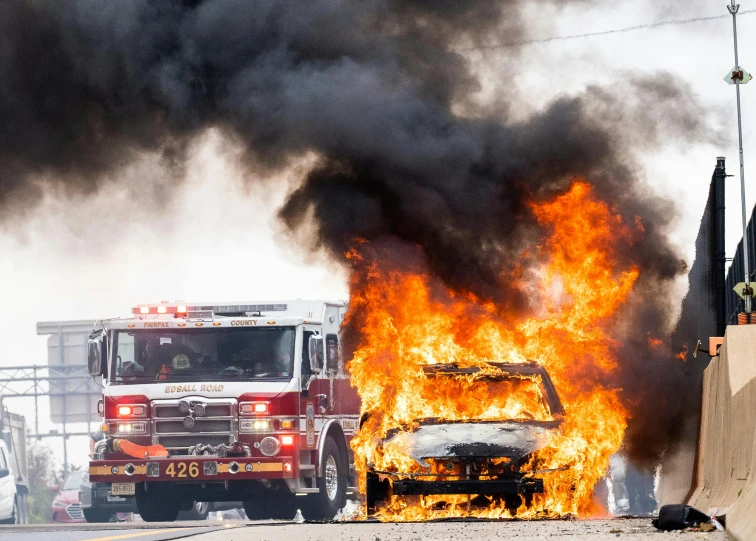 a fire truck and a fire in a parking lot