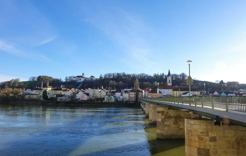 there is a bridge spanning the water from a town