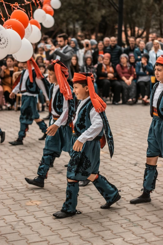 a group of s in costumes walking down the street