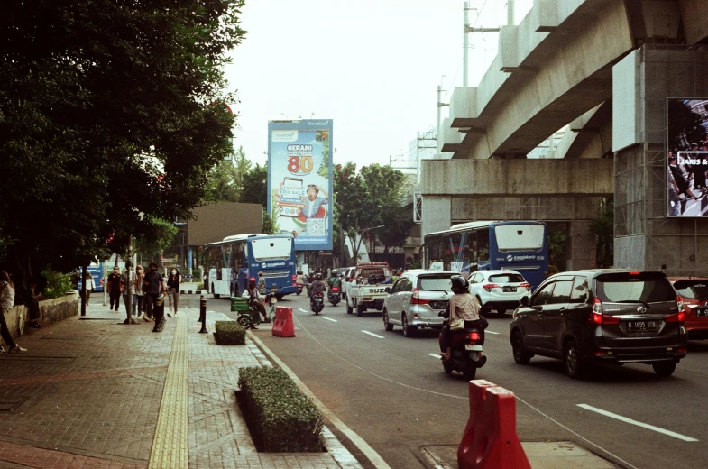 a street with lots of cars and buses