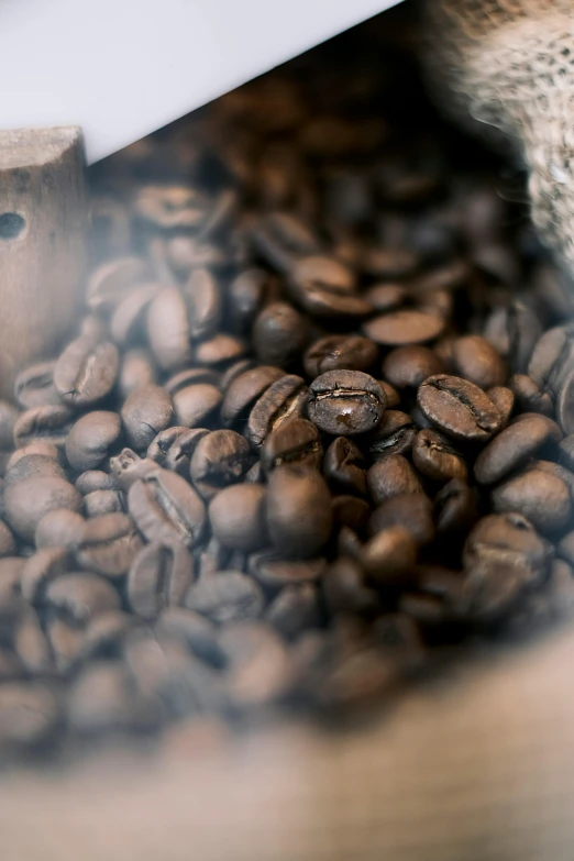 a pile of coffee beans sitting on top of a wooden table