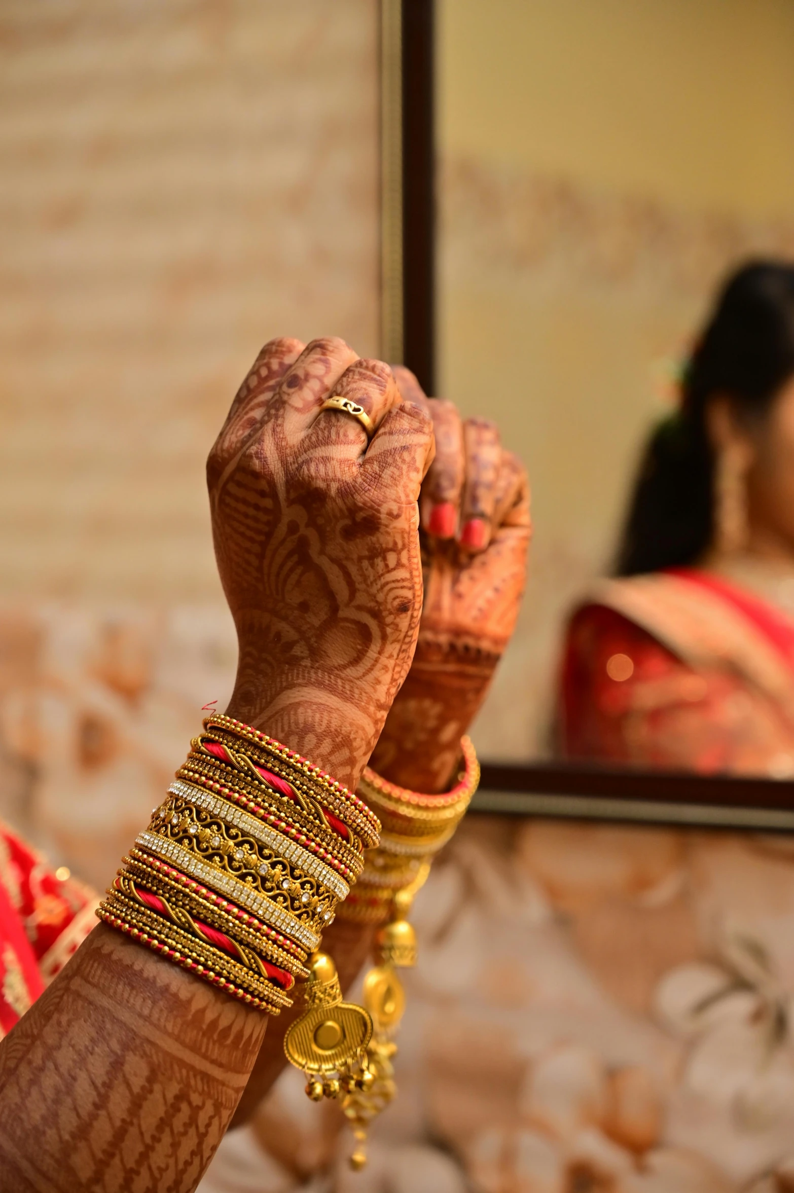 bride with many celets standing in front of a mirror