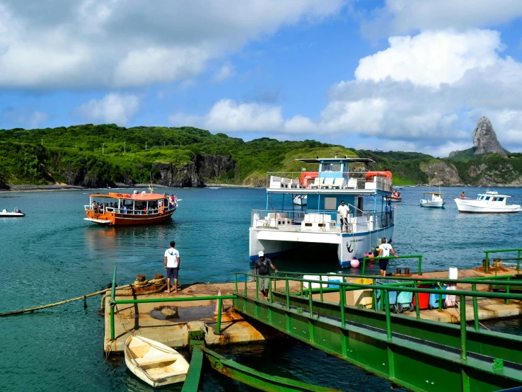 boats moored in an idyllic sea by a dock