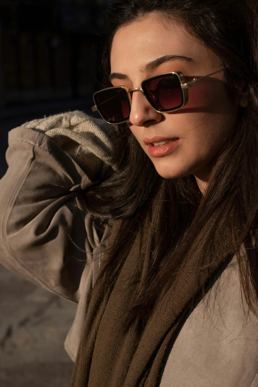 a woman wearing sunglasses is posing for the camera