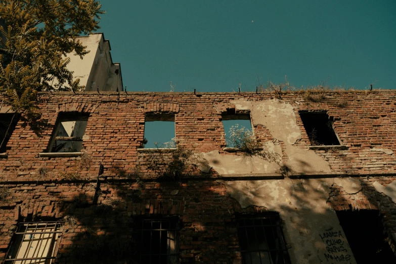 the brick building has three windows with little windows in it