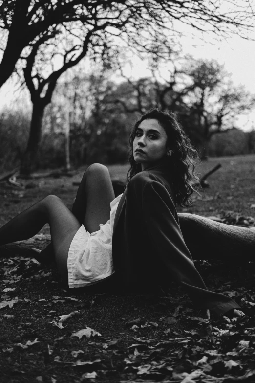 a beautiful young woman sitting on the ground