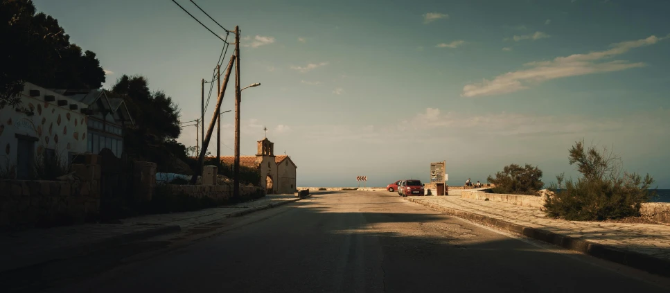 a person is standing on the road as a car approaches