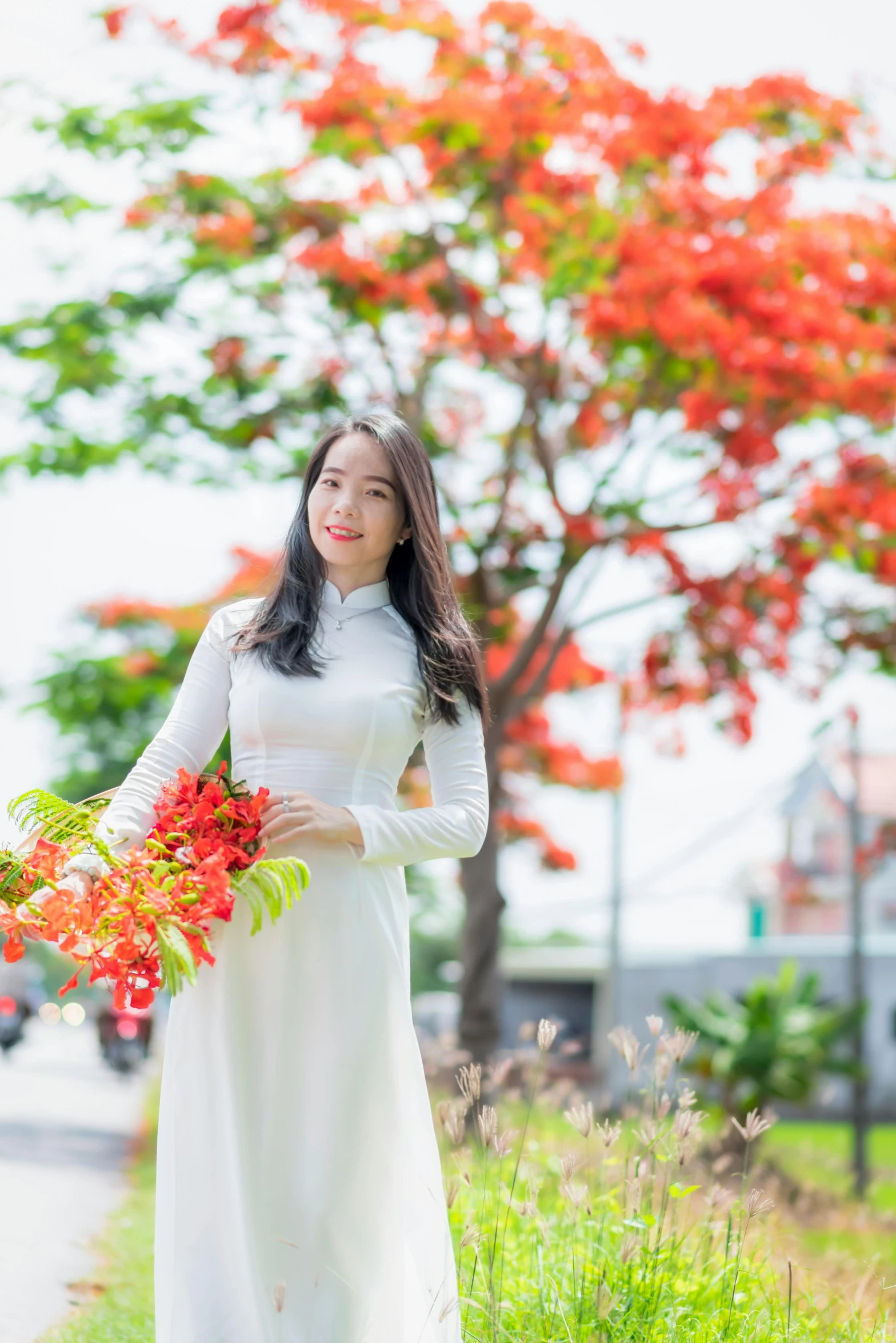 a woman in white posing with a bouquet of flowers