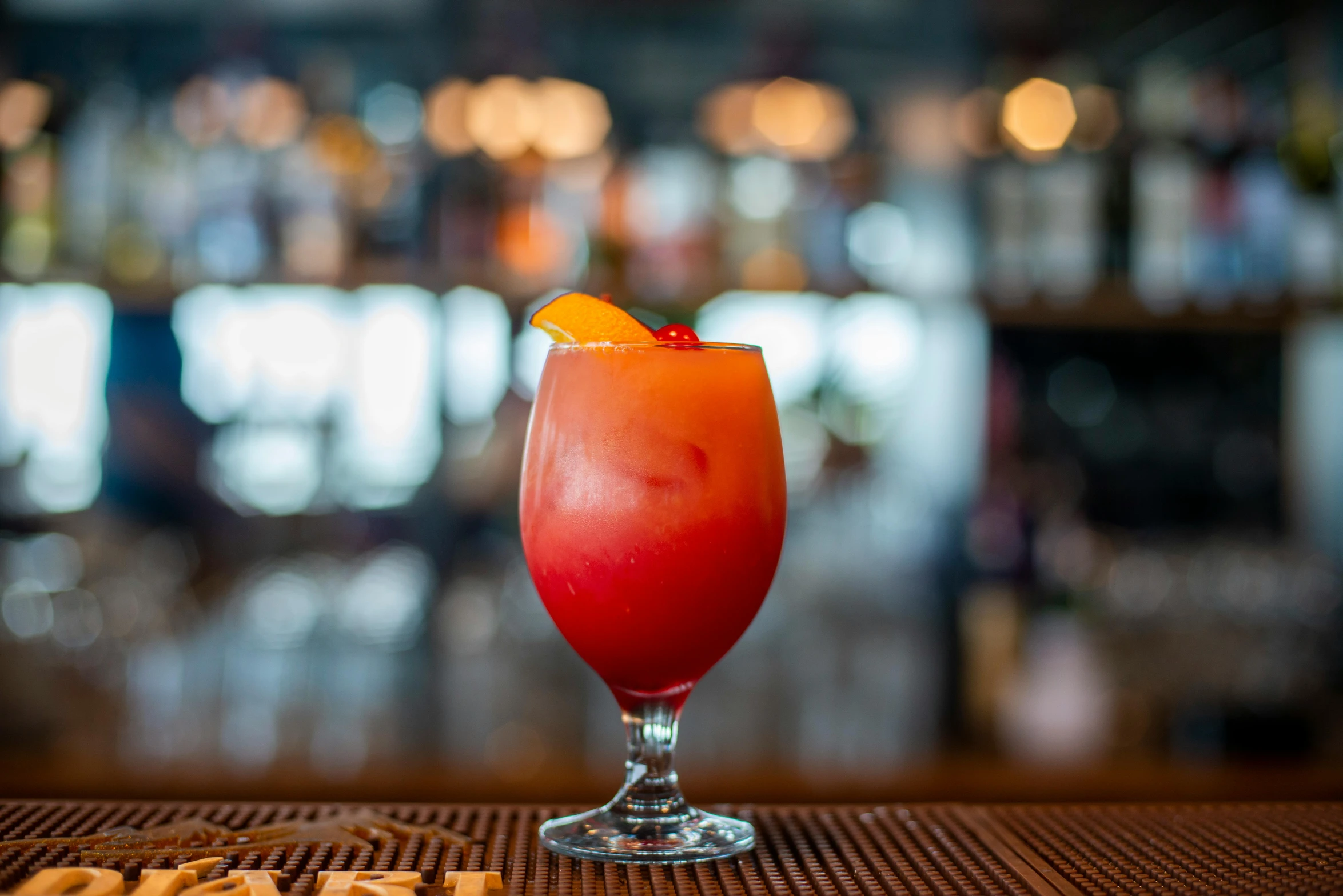 an orange garnish on a drink in a glass