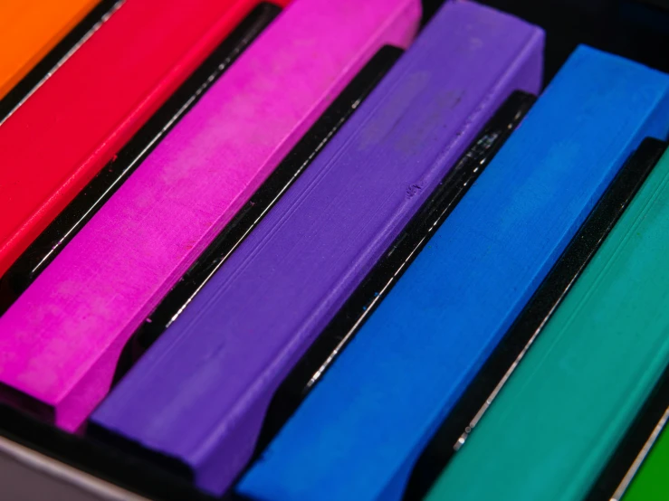 an open suitcase containing various colored papers