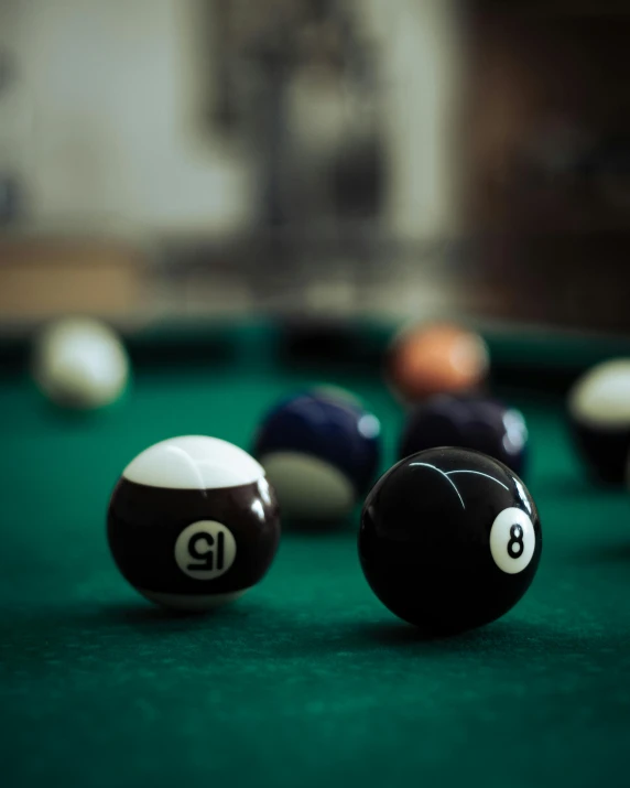 billards are lined up on a green table