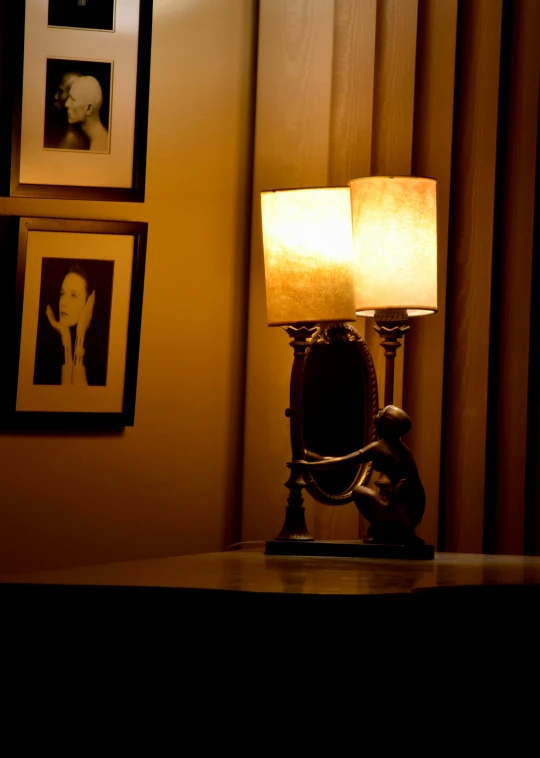 an old phone and lamp sitting on a desk