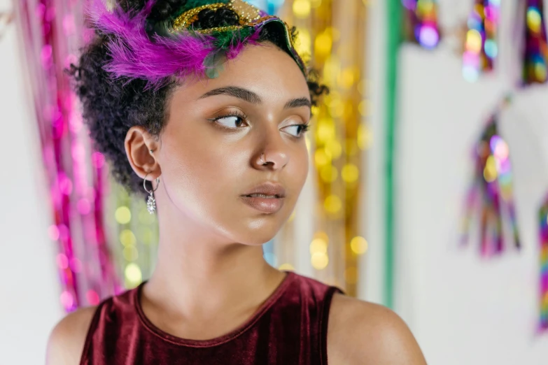 a young woman with colorful hair and a bun in a room