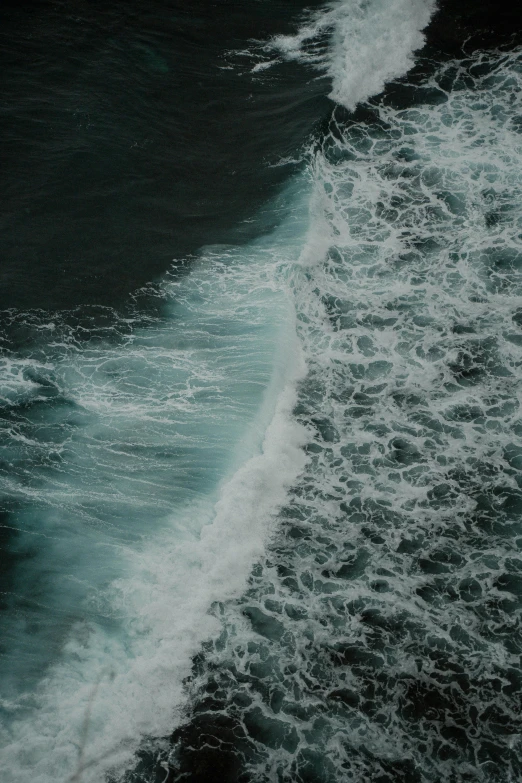 a view from the sky at some waves coming in to shore