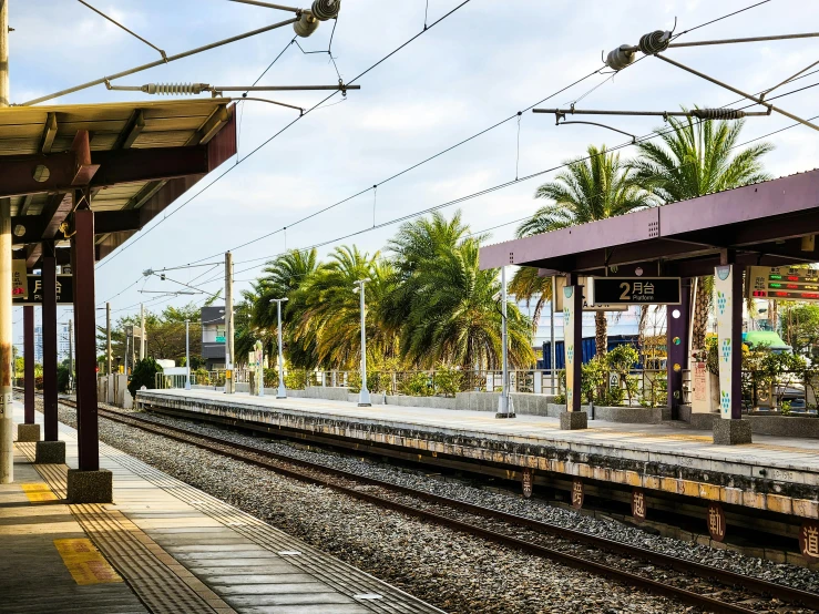 the train is arriving to the station and the passengers are waiting