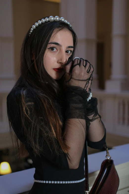 a beautiful young lady wearing black holding onto her wrist