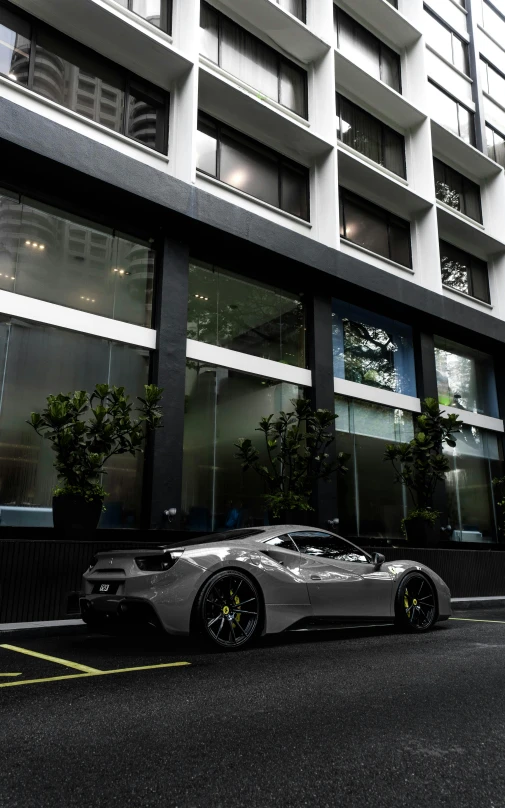 a silver ferrari parked on the side of the street