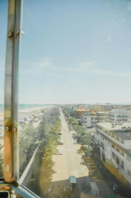 a view from a train window showing a road