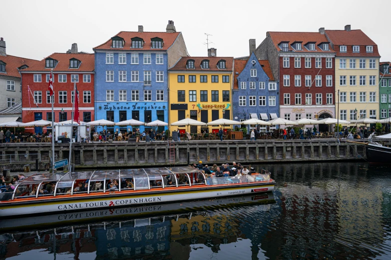 boats are on the water near many different colored buildings