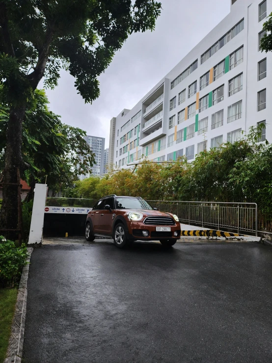 the orange car is parked in front of a building