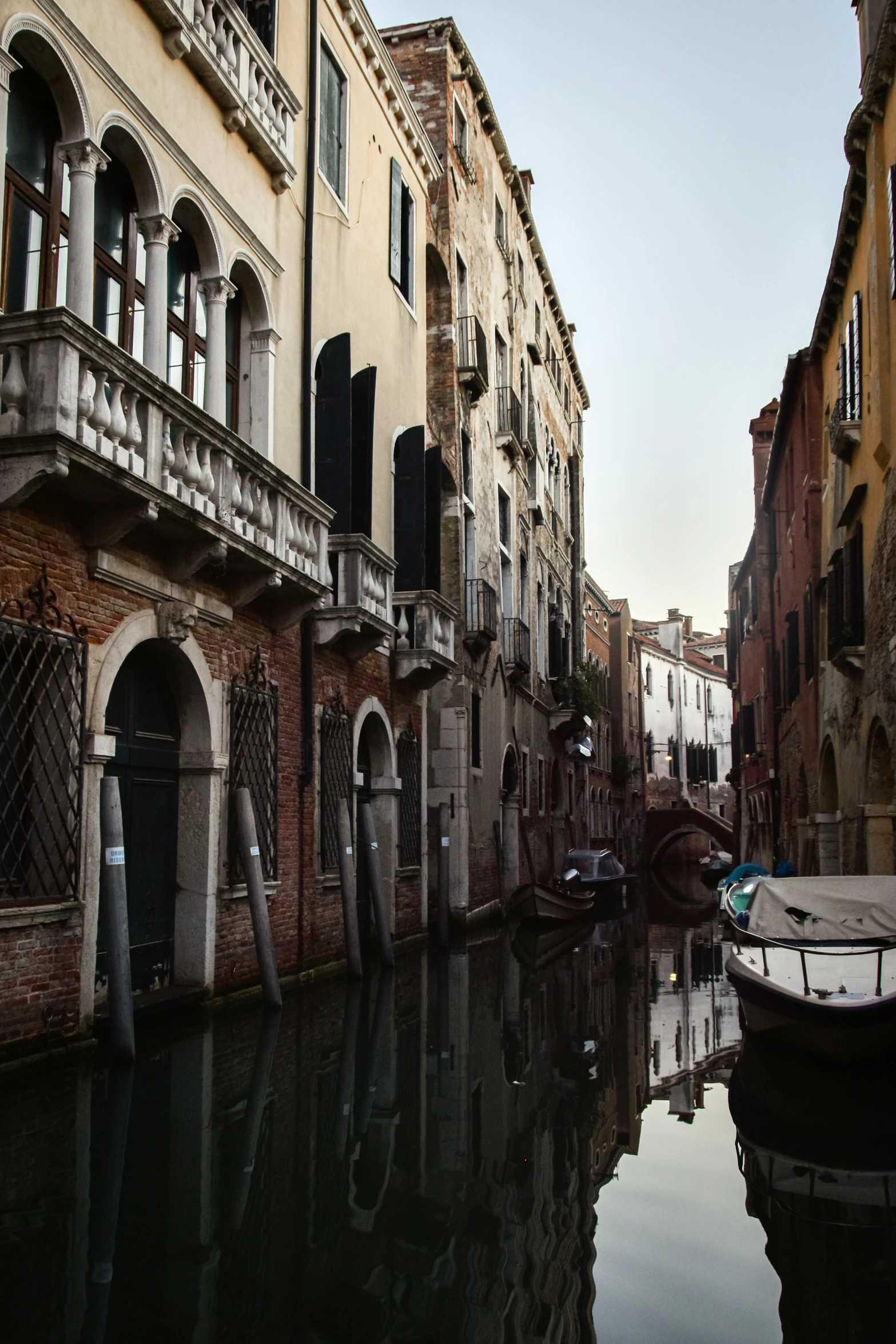 a boat sitting on the side of a river next to buildings