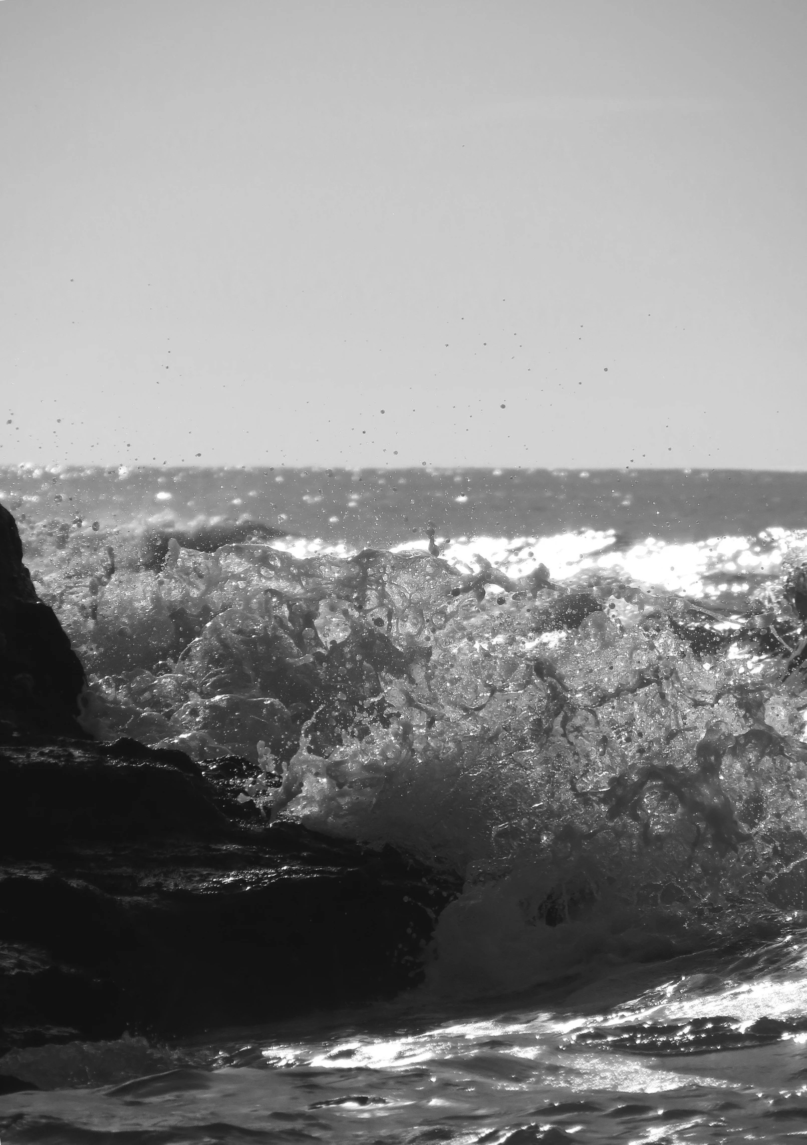 a surfer rides a wave on top of some rocks