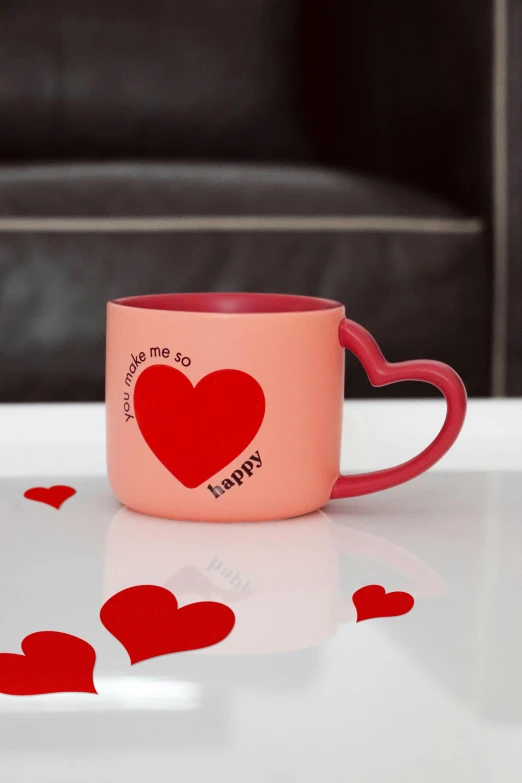 an artistically designed mug on the table with a bunch of hearts around it