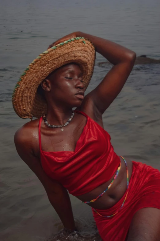 a woman wearing a straw hat and holding her back