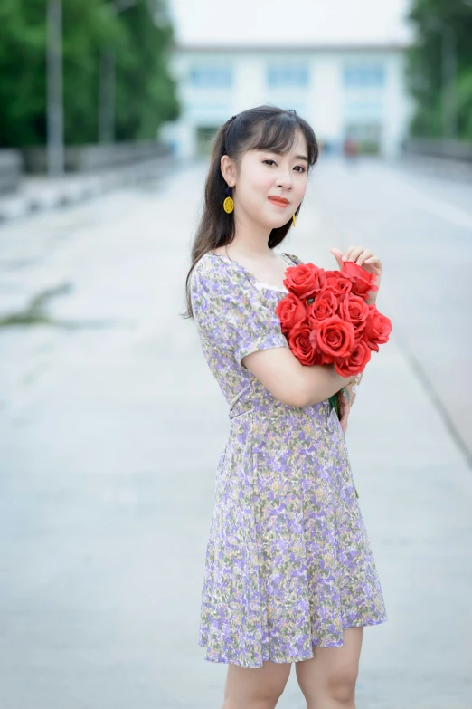 young lady holding a large bunch of flowers